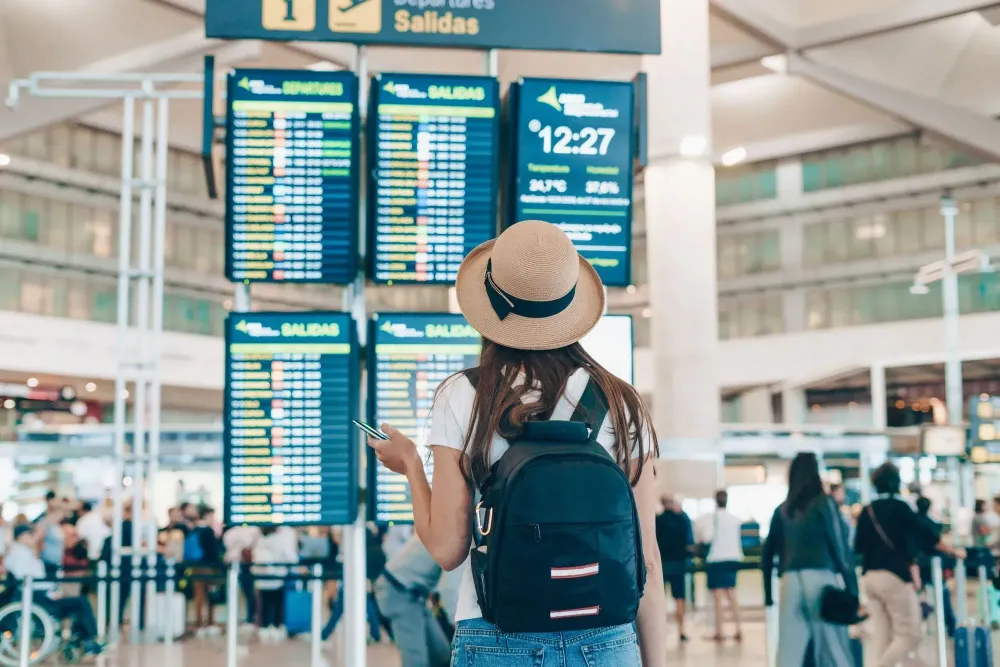 woman looking at international travel board.